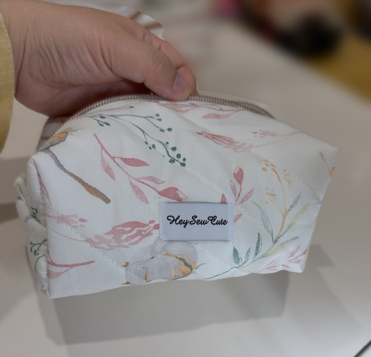 Daily Muse cotton handmade makeup bag held in hand with original table and natural shadow