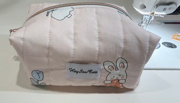 Blush Bunny pink quilted makeup bag with bunny and tulip print, original front view