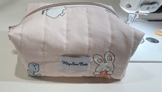 Blush Bunny pink quilted makeup bag with bunny and tulip print, original front view