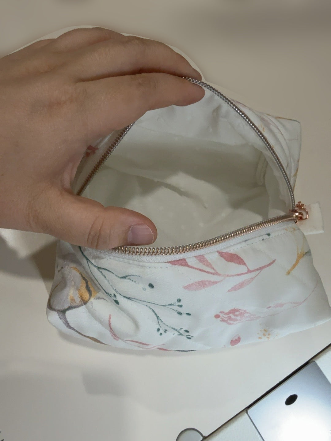 Cotton Bloom cream lining held open by hand on original table