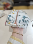Load image into Gallery viewer, Wildflower Meadow zip detail held in hand in original sewing space
